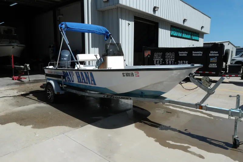 Slide: The Image of 1982 Boston Whaler Montauk 17 CC boat on trailer, parked outside a building. - 9