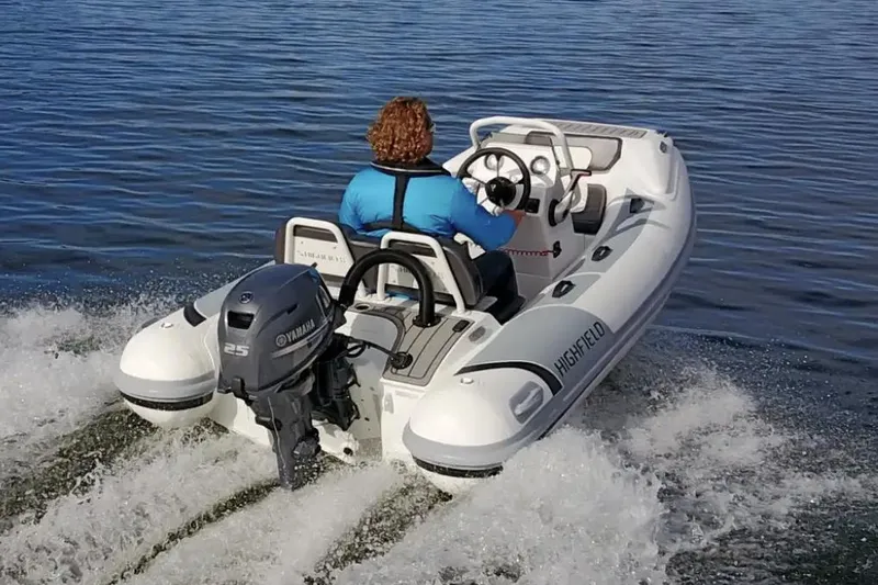 Slide: The Image of Manufacturer Provided Image: 2023 Highfield Sport 330 inflatable boat with Yamaha outboard motor on water. - 9