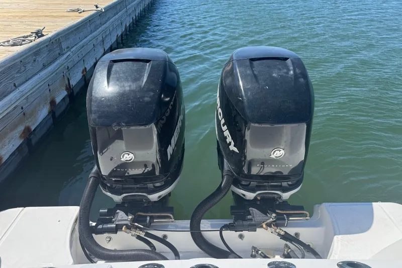 Slide: The Image of Twin Mercury outboard engines on a 2014 Boston Whaler 280 Outrage at dock. - 13