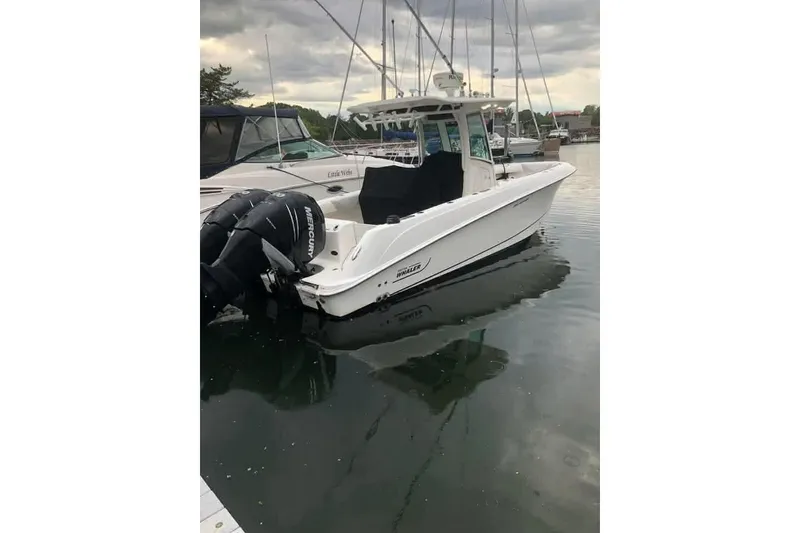 Slide: The Image of 2014 Boston Whaler 280 Outrage boat docked in a marina. - 17