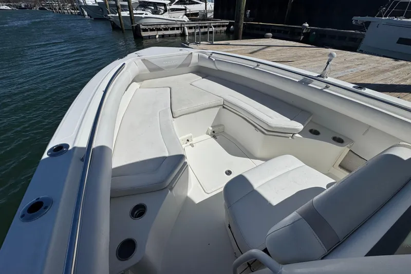Slide: The Image of 2014 Boston Whaler 280 Outrage boat interior with white seating and cup holders. - 8