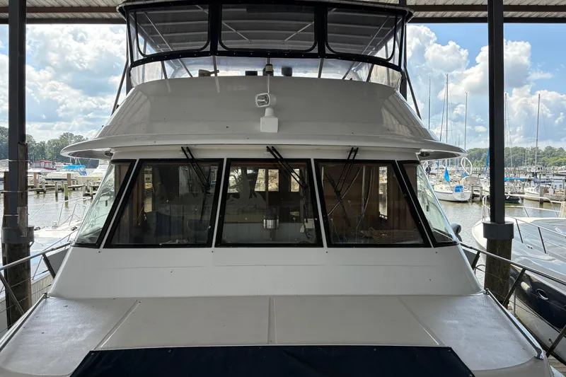 The Image of 1989 Jefferson 60' Marquessa Motor Yacht deck with wooden flooring and storage boxes. - 0
