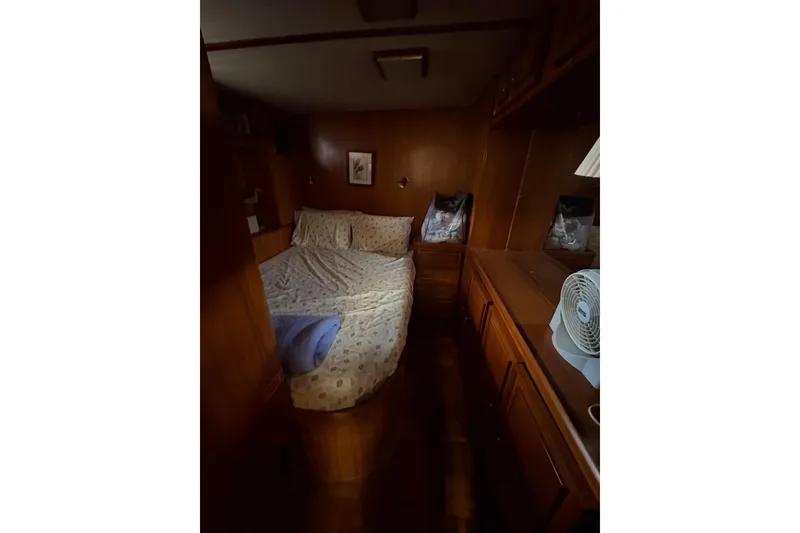 Slide: The Image of Cozy bedroom interior of 1989 Jefferson 60' Marquessa Motor Yacht with wooden furnishings. - 10