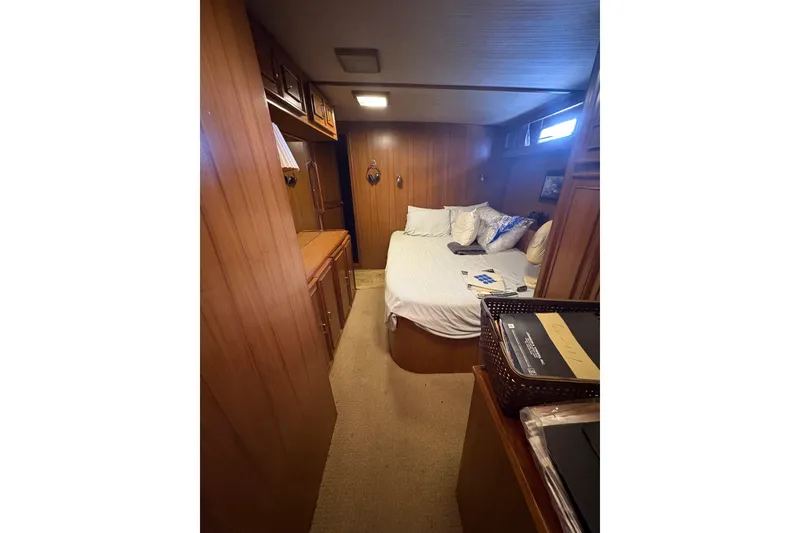 Slide: The Image of Cozy bedroom interior of 1989 Jefferson 60' Marquessa Motor Yacht with wood paneling. - 11
