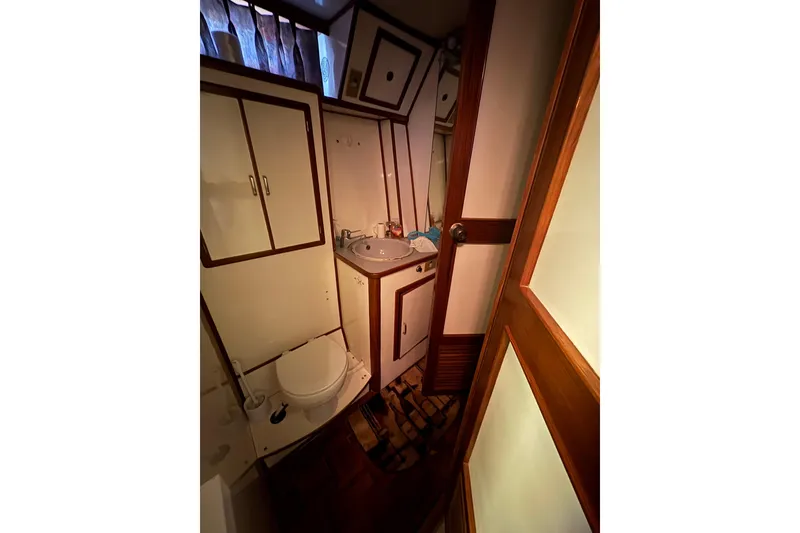 Slide: The Image of Bathroom interior of 1989 Jefferson 60' Marquessa Motor Yacht, featuring sink and toilet. - 12