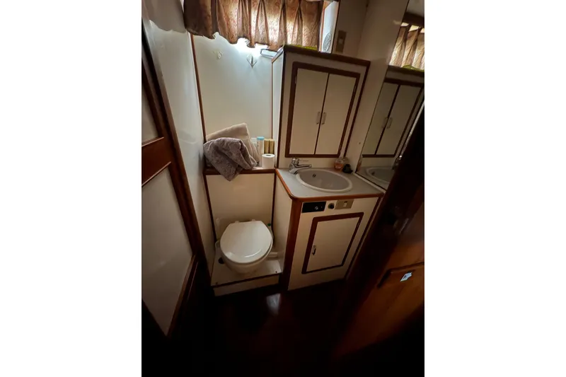 Slide: The Image of Bathroom interior of 1989 Jefferson 60' Marquessa Motor Yacht with sink and toilet. - 13