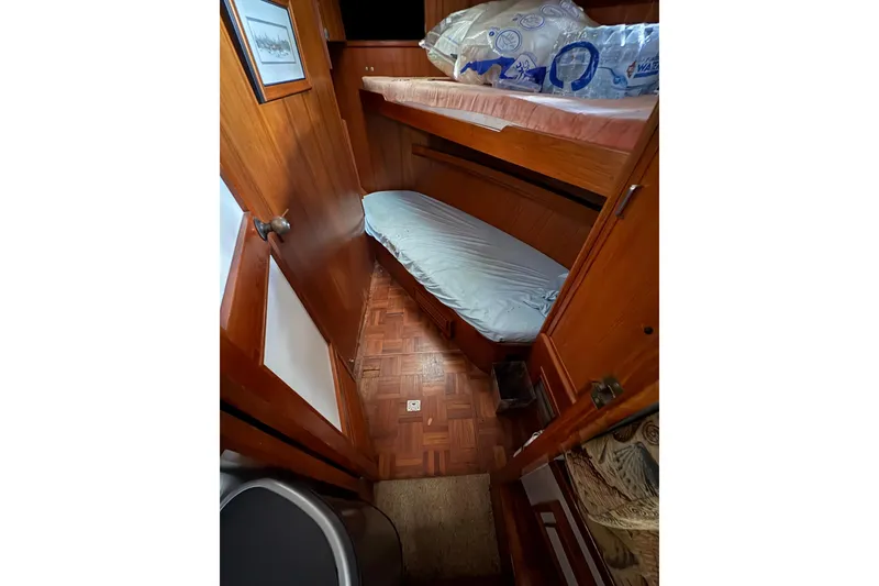 Slide: The Image of Interior cabin of 1989 Jefferson 60' Marquessa Motor Yacht with wooden finishes and bunk beds. - 14