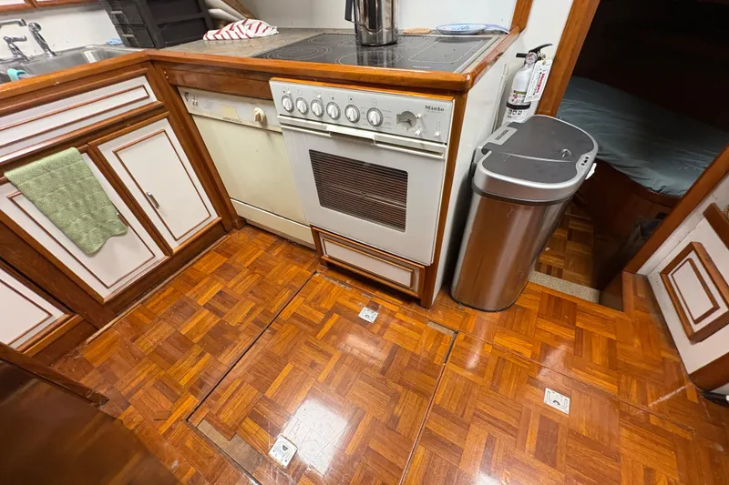 Slide: The Image of Galley kitchen in 1989 Jefferson 60' Marquessa Motor Yacht with wood flooring and appliances. - 17