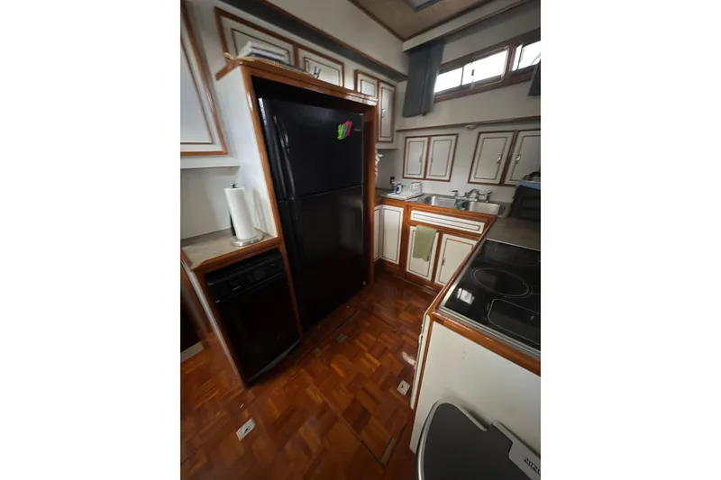 Slide: The Image of Kitchen area of a 1989 Jefferson 60' Marquessa Motor Yacht with wood flooring. - 18