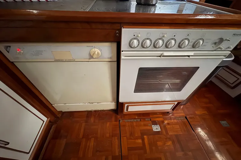 Slide: The Image of Kitchen appliances on a 1989 Jefferson 60' Marquessa Motor Yacht, featuring a dishwasher and oven. - 19