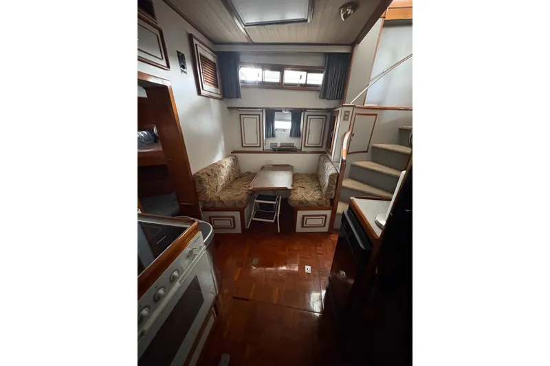 Slide: The Image of Interior of 1989 Jefferson 60' Marquessa Motor Yacht with cozy seating and wooden finishes. - 20