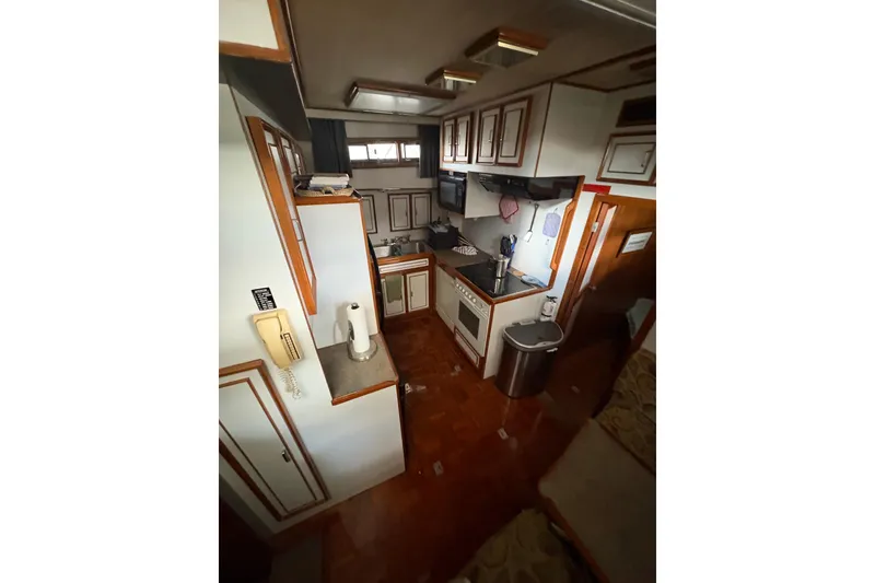 Slide: The Image of Interior of 1989 Jefferson 60' Marquessa Motor Yacht, featuring a compact kitchen area. - 22