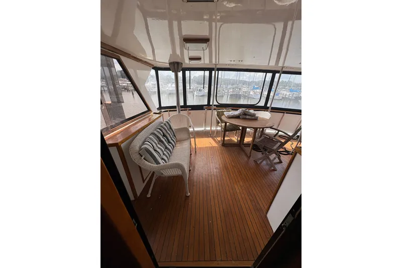 Slide: The Image of 1989 Jefferson 60' Marquessa Motor Yacht interior with wicker seating and wooden flooring. - 23