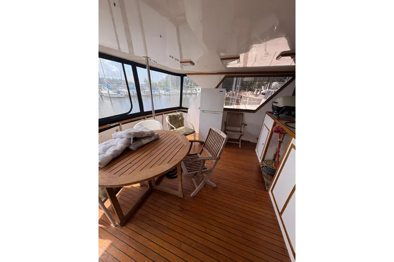Slide: The Image of 1989 Jefferson 60' Marquessa Motor Yacht interior with wooden deck and seating area. - 24