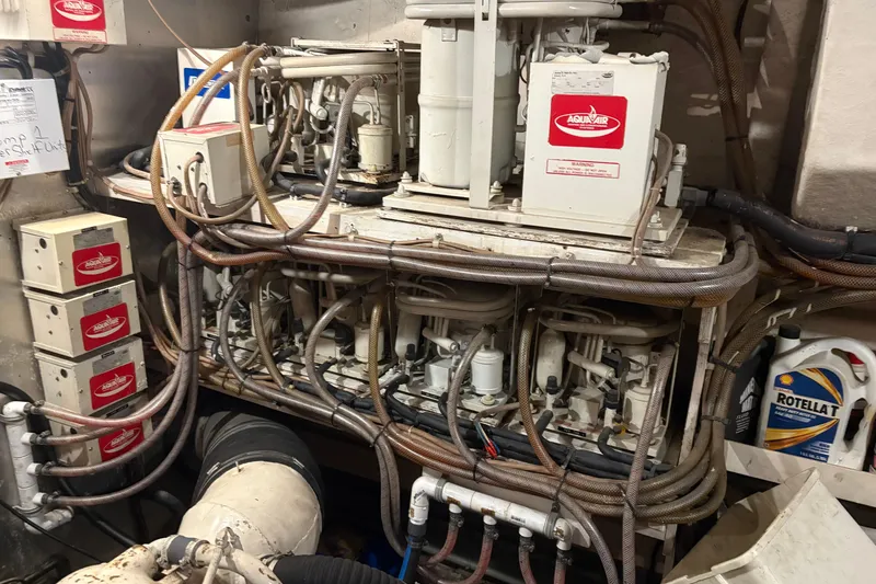 Slide: The Image of Engine room of a 1989 Jefferson 60' Marquessa Motor Yacht with complex machinery and wiring. - 6