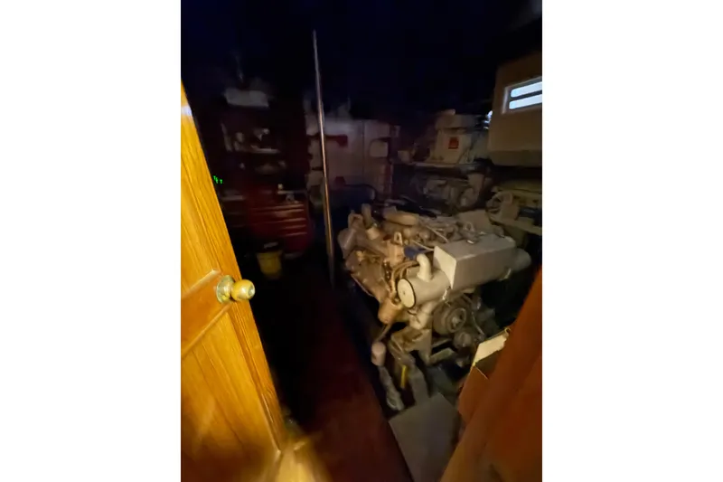 Slide: The Image of Engine room of a 1989 Jefferson 60' Marquessa Motor Yacht, showcasing machinery and equipment. - 9