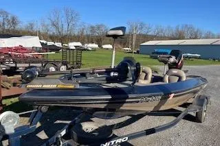 Slide: The Image of 2001 Nitro 700 LX SC boat on trailer, parked outdoors in a rural setting. - 3