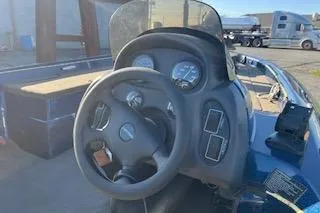 Slide: The Image of 2001 Nitro 700 LX SC boat dashboard with steering wheel and gauges. - 5