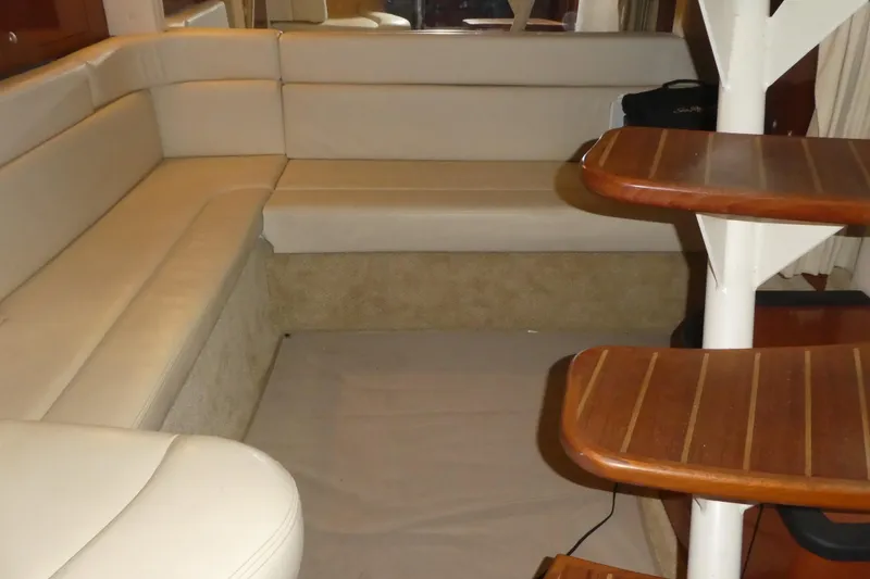 Slide: The Image of Interior of 2005 Sea Ray 340 Sundancer with beige seating and wooden table. - 11