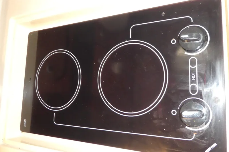 Slide: The Image of Electric stovetop on a 2005 Sea Ray 340 Sundancer yacht, featuring dual burners and control knobs. - 15