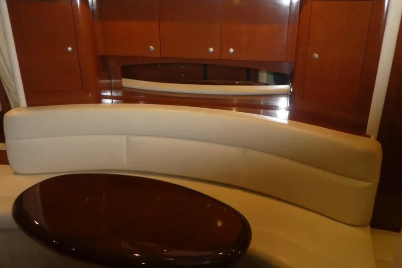 Slide: The Image of Luxurious interior of 2005 Sea Ray 340 Sundancer with curved seating and wooden cabinetry. - 16