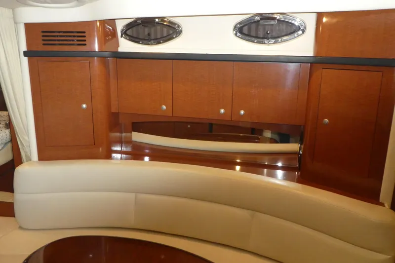 Slide: The Image of Interior of 2005 Sea Ray 340 Sundancer with wood cabinetry and beige seating. - 17