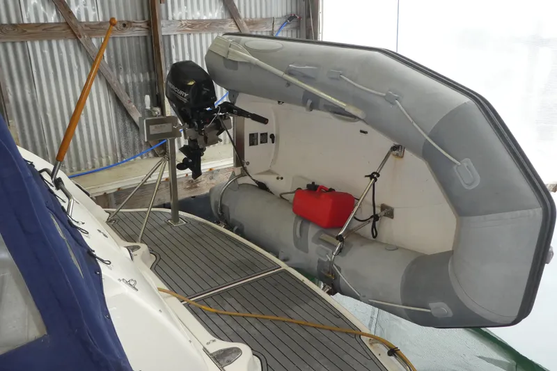 Slide: The Image of 2005 Sea Ray 340 Sundancer with inflatable dinghy and outboard motor on deck. - 2