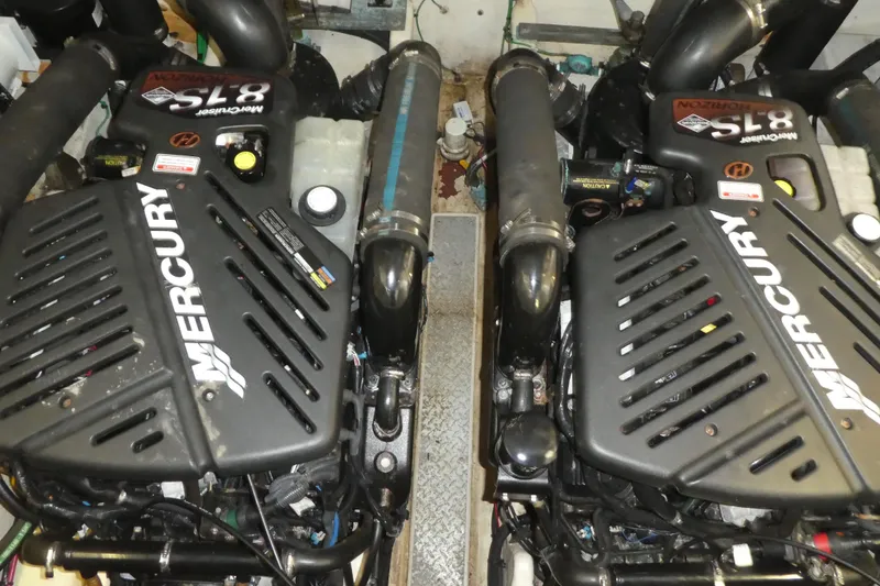 Slide: The Image of Twin Mercury engines in a 2005 Sea Ray 340 Sundancer boat engine room. - 22