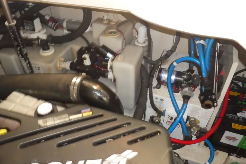 Slide: The Image of Engine compartment of a 2005 Sea Ray 340 Sundancer with visible hoses and components. - 25