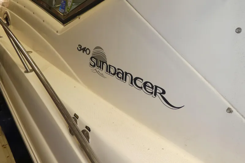 Slide: The Image of 2005 Sea Ray 340 Sundancer boat with sleek design and branding. - 30