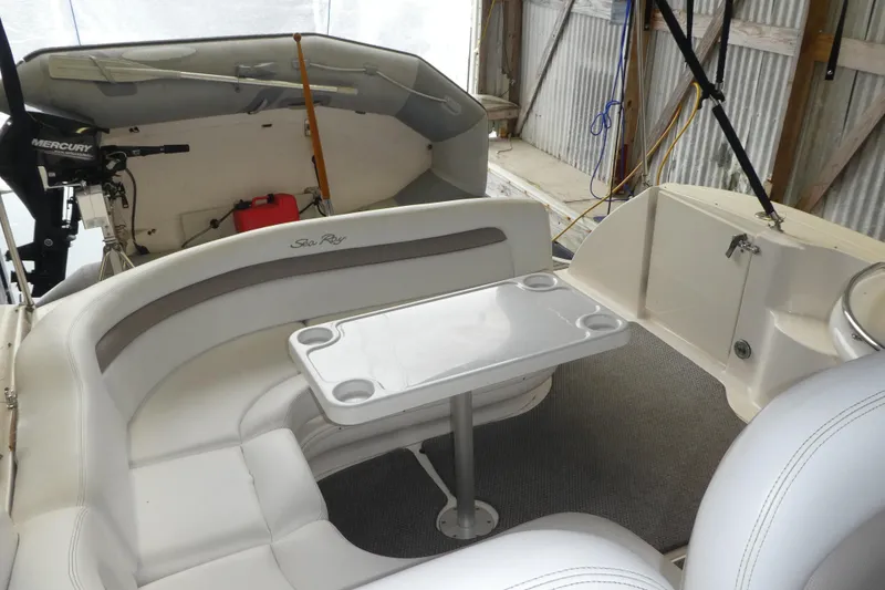 Slide: The Image of 2005 Sea Ray 340 Sundancer interior with seating and table in a boat garage. - 5