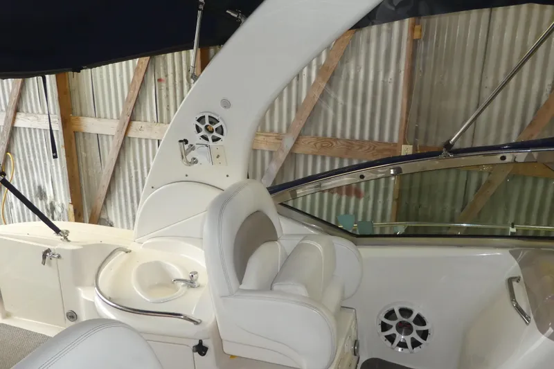 Slide: The Image of 2005 Sea Ray 340 Sundancer interior with white seating and built-in speaker system. - 6
