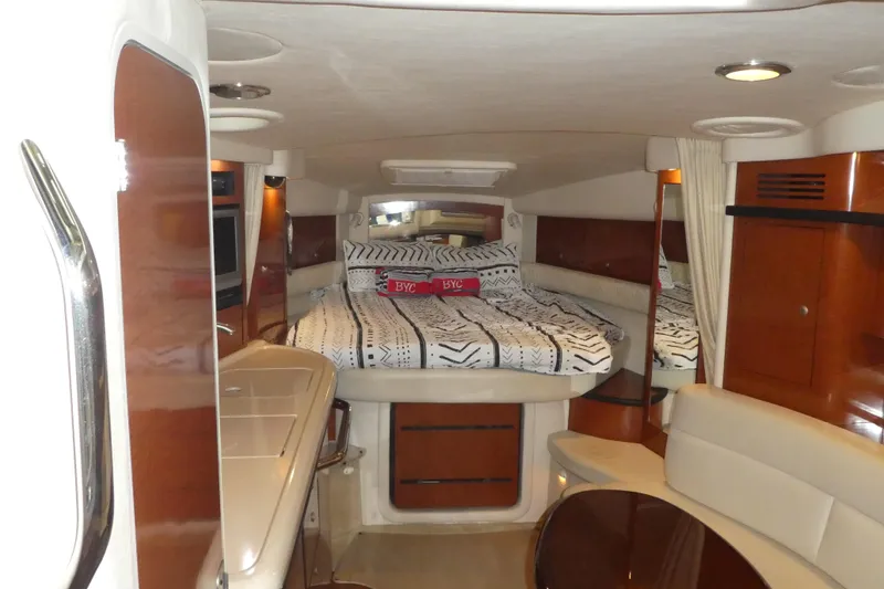 Slide: The Image of Interior of 2005 Sea Ray 340 Sundancer yacht with cozy bed and elegant wood finishes. - 8