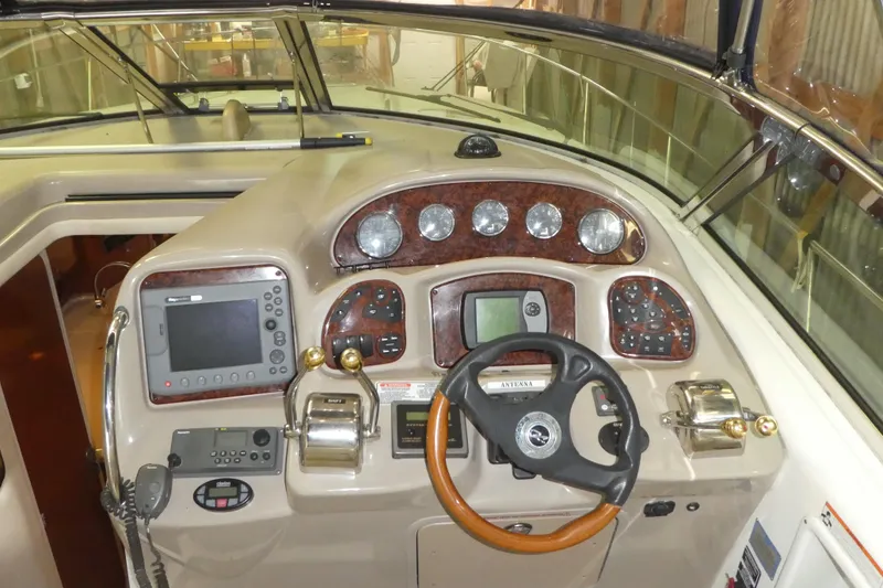 Slide: The Image of Cockpit of 2005 Sea Ray 340 Sundancer with navigation instruments and steering wheel. - 9