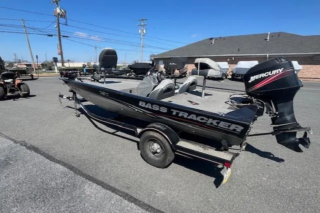 Slide: The Image of 2008 Tracker Pro Team 175 TXW bass boat with Mercury outboard motor on trailer. - 11