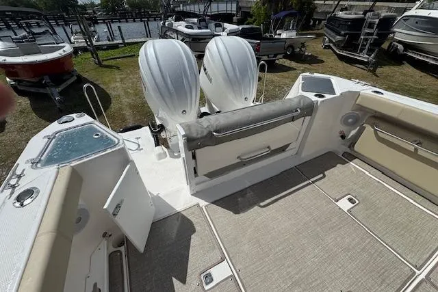 Slide: The Image of 2026 Cutwater C-288 Coupe boat deck with dual outboard motors, docked near water. - 16