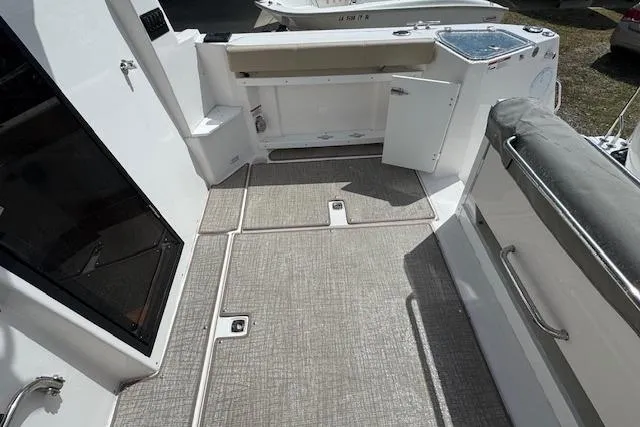 Slide: The Image of 2026 Cutwater C-288 Coupe boat interior with open storage compartments and seating area. - 17
