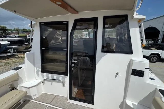 Slide: The Image of 2026 Cutwater C-288 Coupe boat exterior with glass door and windows. - 20