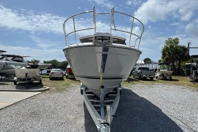 Slide: The Image of 2026 Cutwater C-288 Coupe boat on trailer, parked outdoors under a partly cloudy sky. - 3