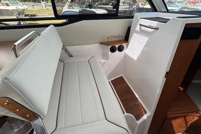 Slide: The Image of 2026 Cutwater C-288 Coupe interior with white seating and wooden accents. - 31