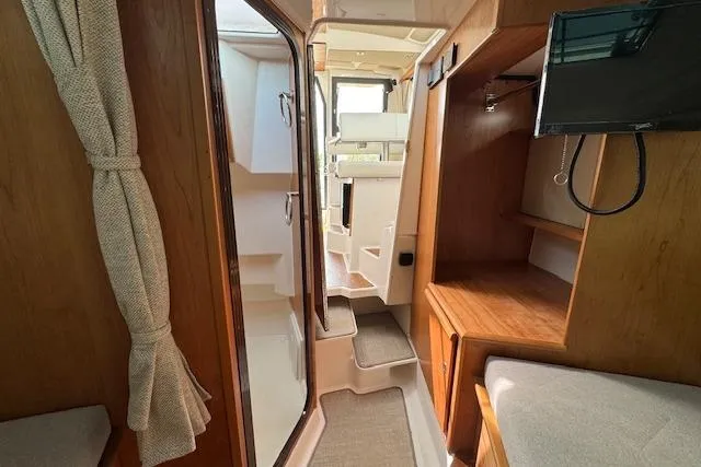 Slide: The Image of Interior of 2026 Cutwater C-288 Coupe boat, featuring cozy cabin and modern amenities. - 34