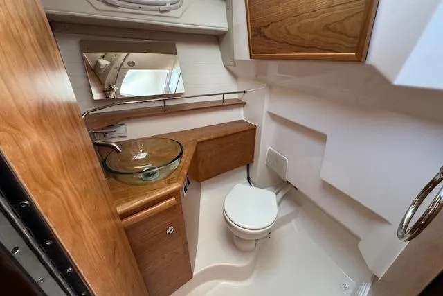 Slide: The Image of 2026 Cutwater C-288 Coupe bathroom with modern fixtures and wooden cabinetry. - 35