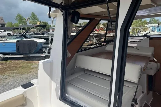 Slide: The Image of 2026 Cutwater C-288 Coupe interior view with seating, docked among other boats. - 39