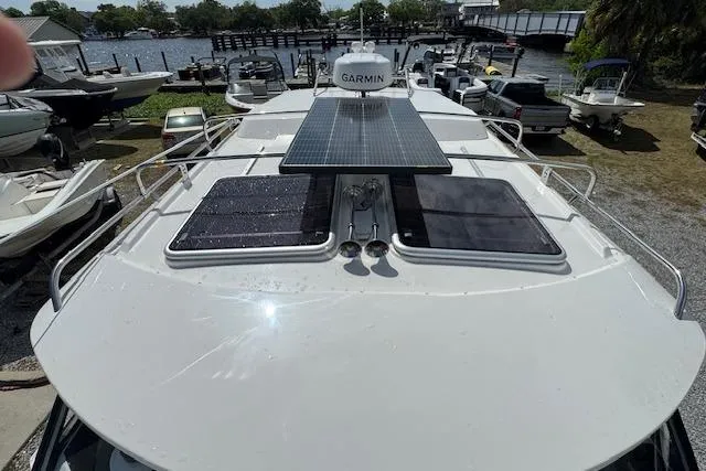 Slide: The Image of 2026 Cutwater C-288 Coupe boat with solar panels and Garmin equipment docked at marina. - 43