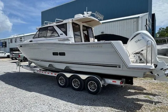 Slide: The Image of 2026 Cutwater C-288 Coupe boat on a trailer, parked outdoors. - 7