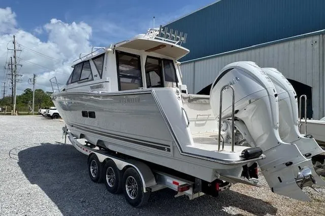 Slide: The Image of 2026 Cutwater C-288 Coupe boat on trailer, parked outdoors near a building. - 8