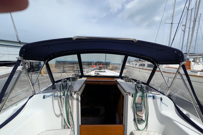 Slide: The Image of Interior of a 1995 Catalina 36 MkII sailboat with cozy seating and wooden cabinetry. - 14