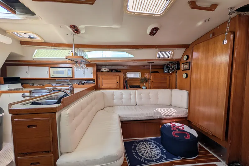 Slide: The Image of Interior of a 1995 Catalina 36 MkII sailboat with cozy seating and wooden cabinetry. - 17