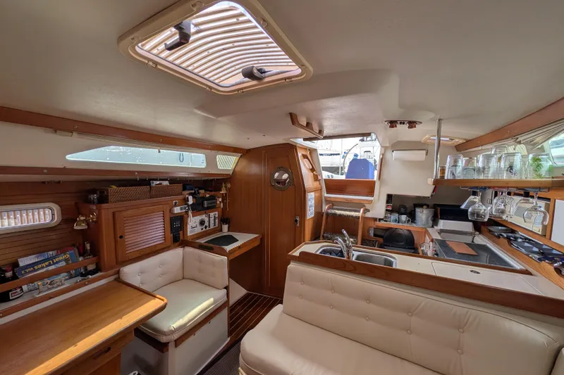 Slide: The Image of Galley stove in 1995 Catalina 36 MkII sailboat, with striped towel and "Live Love Lake" cloth. - 18