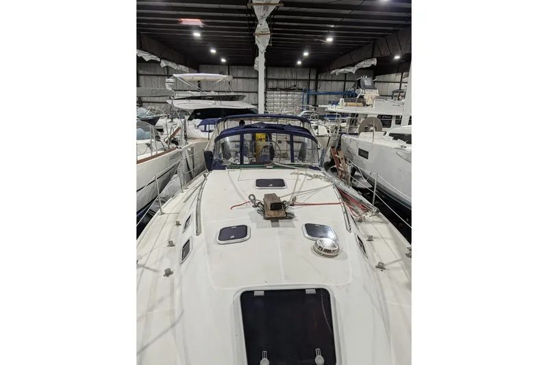 Slide: The Image of 1995 Catalina 36 MkII sailboat in indoor storage, showcasing deck and rigging. - 2